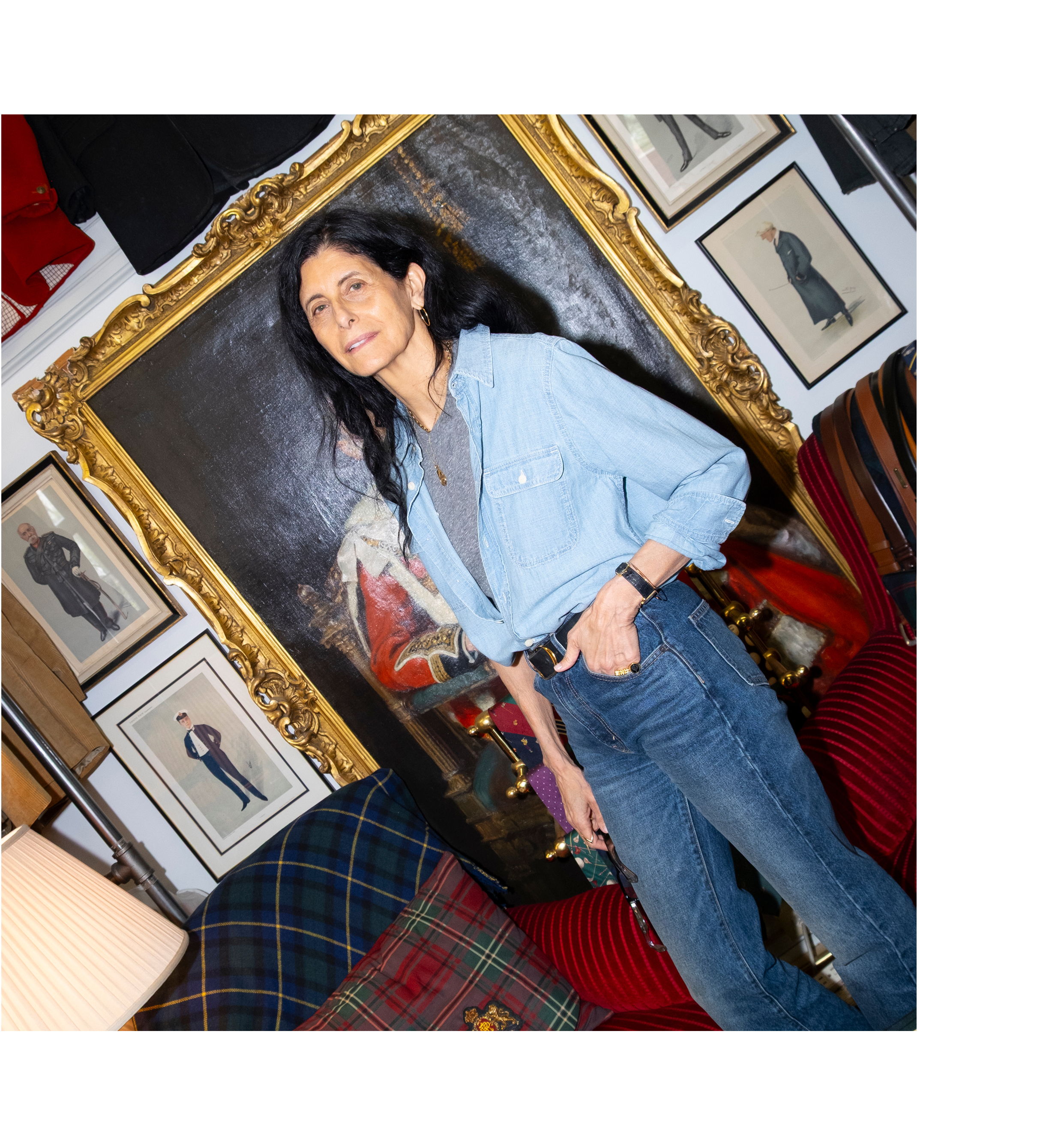 A woman in a blue shirt poses in a decorated room.