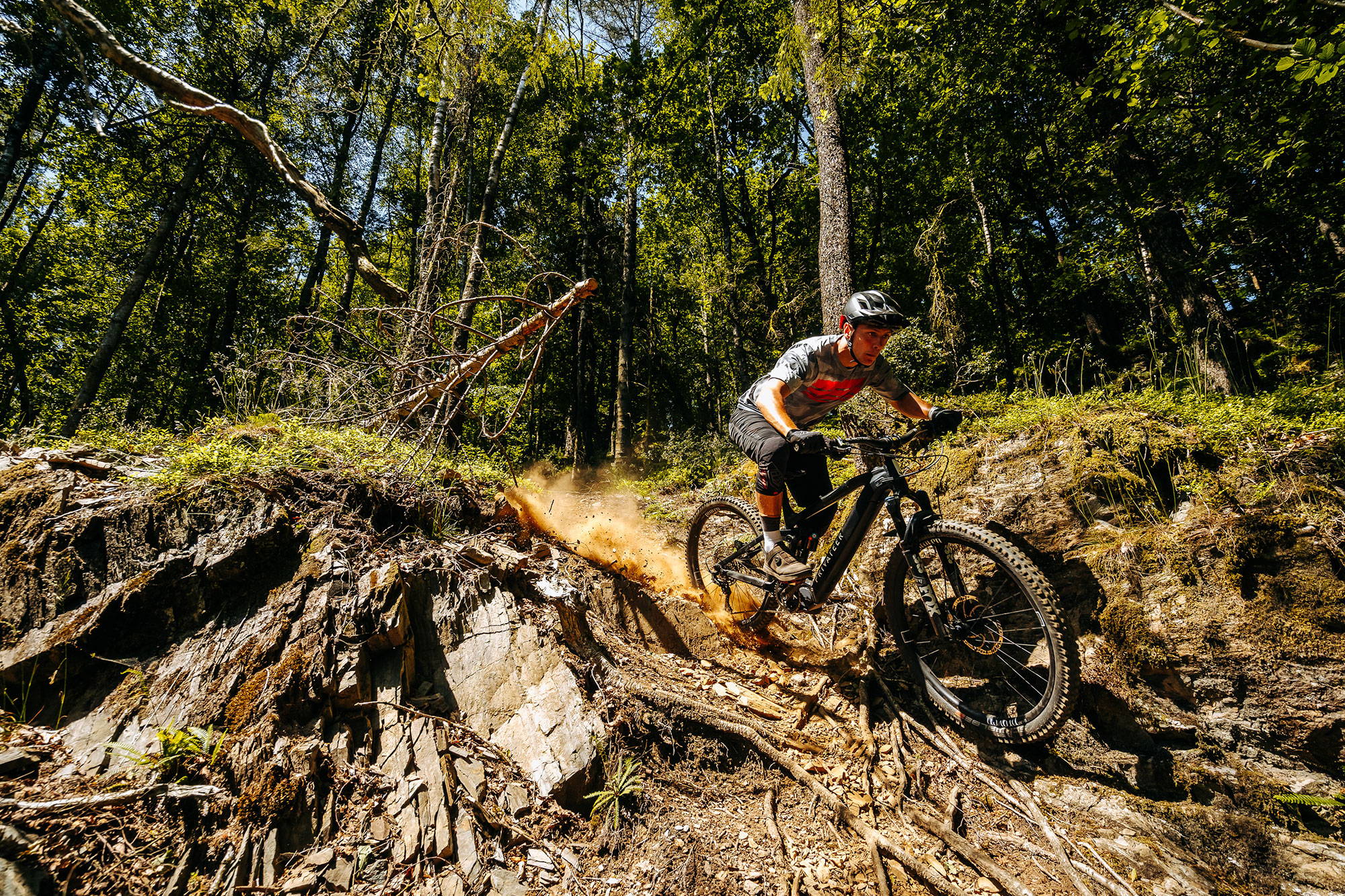 Full suspension electric mtb being ridden down a trail