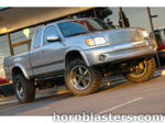 Front three-quarter Lance's silver 1999 Toyota Tundra extended cab billet chrome grille lifted off-road wheels golden hour Shocker XL train horn featured customer install gallery photo 1