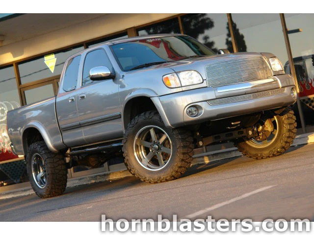 Front three-quarter Lance's silver 1999 Toyota Tundra extended cab billet chrome grille lifted off-road wheels golden hour Shocker XL train horn featured customer install gallery photo 1