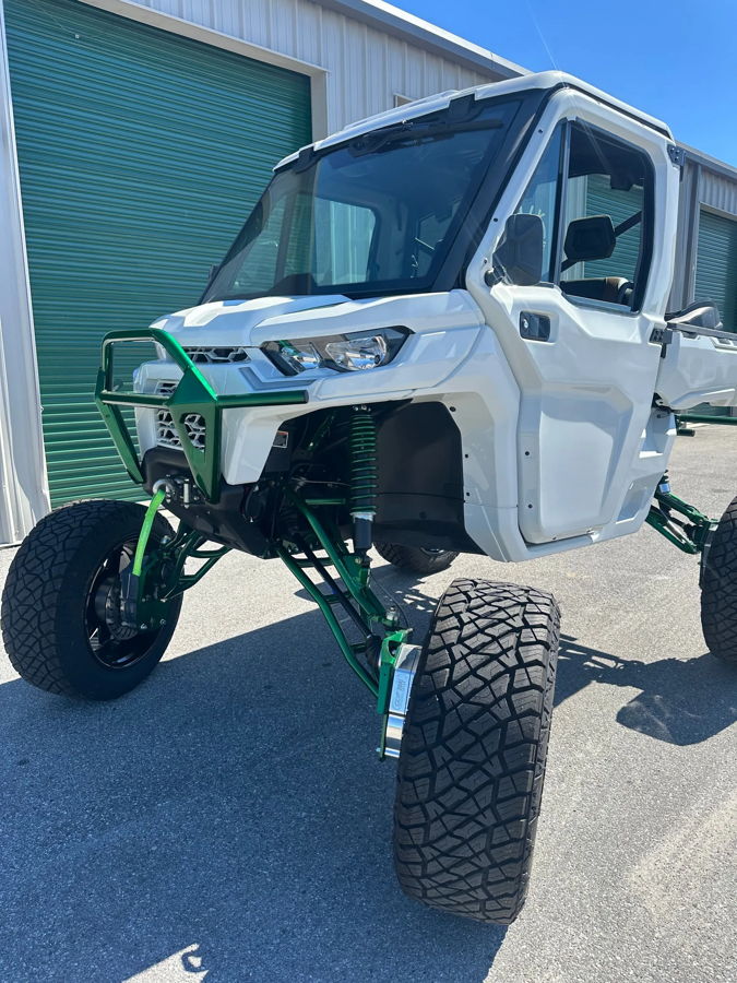 Front three-quarter white Can-Am Defender neon green lift kit off-road tires green roll-up door Rich's 2021 Defender Conductor's Special 244K gallery photo 2
