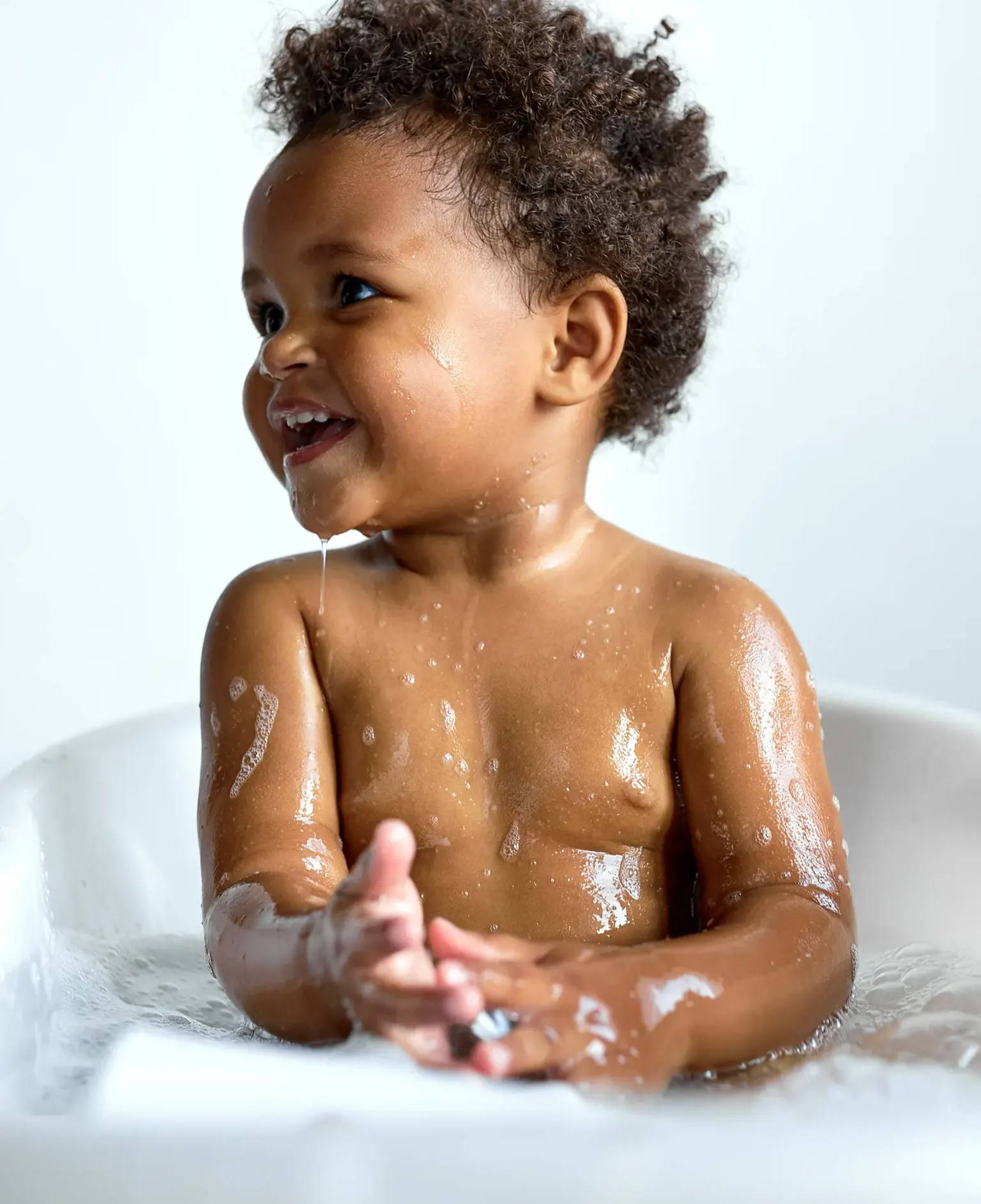 a toddler in a bath tub 