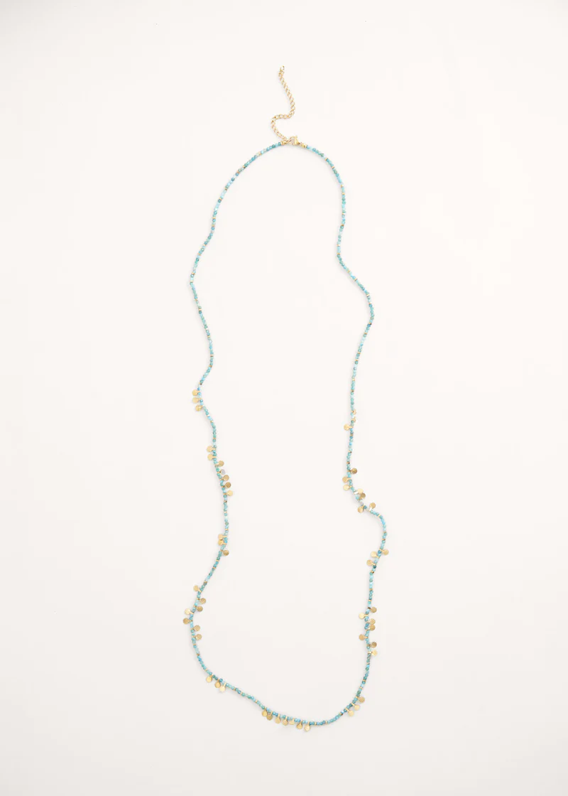A long beaded necklace with turquoise crystals and gold discs