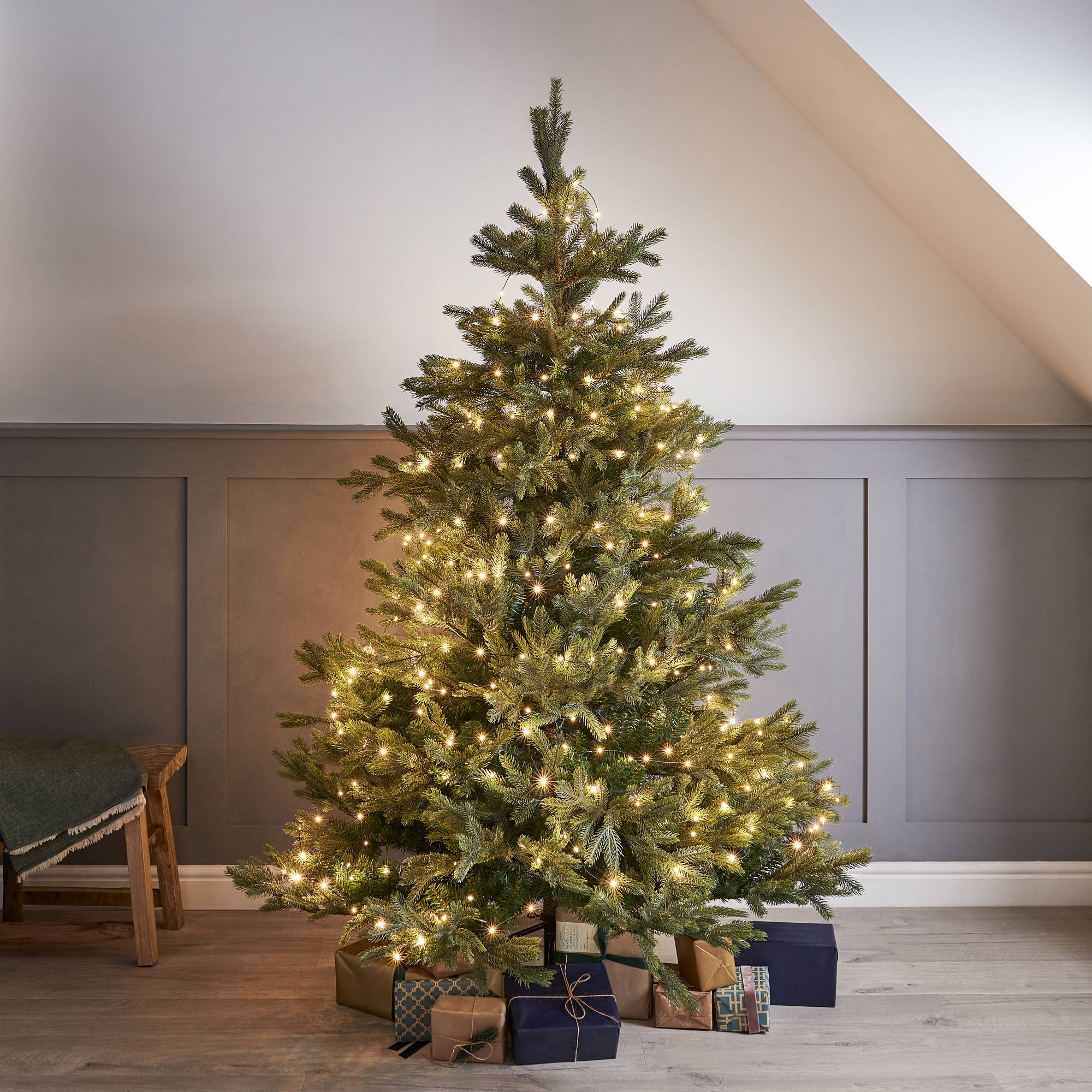 Image of a Christmas tree with lights and presents.