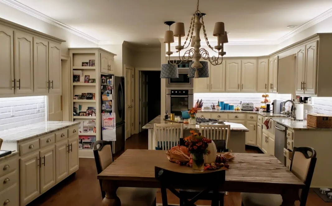 Family kitchen with dinner table and under cabinet lighting using LED strip lights