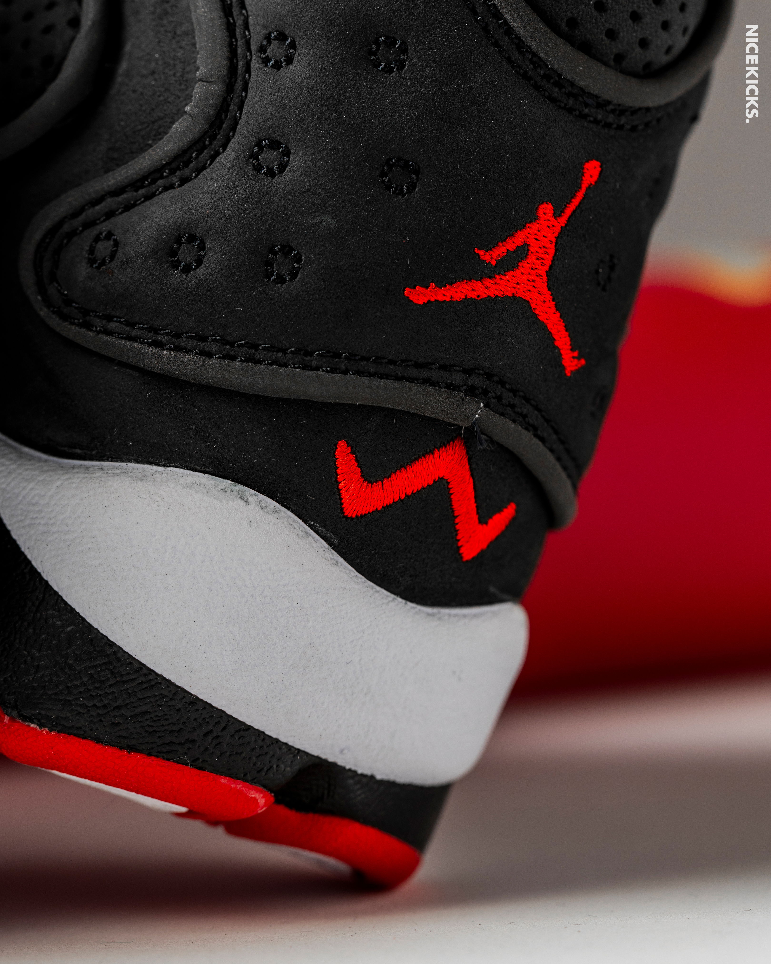 Close-up of a black and red sneaker with a Jumpman logo.