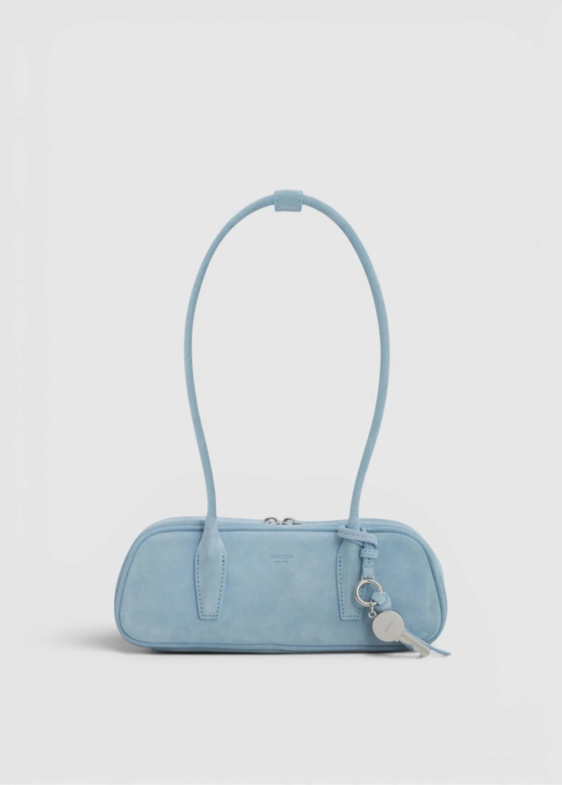 Light blue handbag with a long handle and keychain.