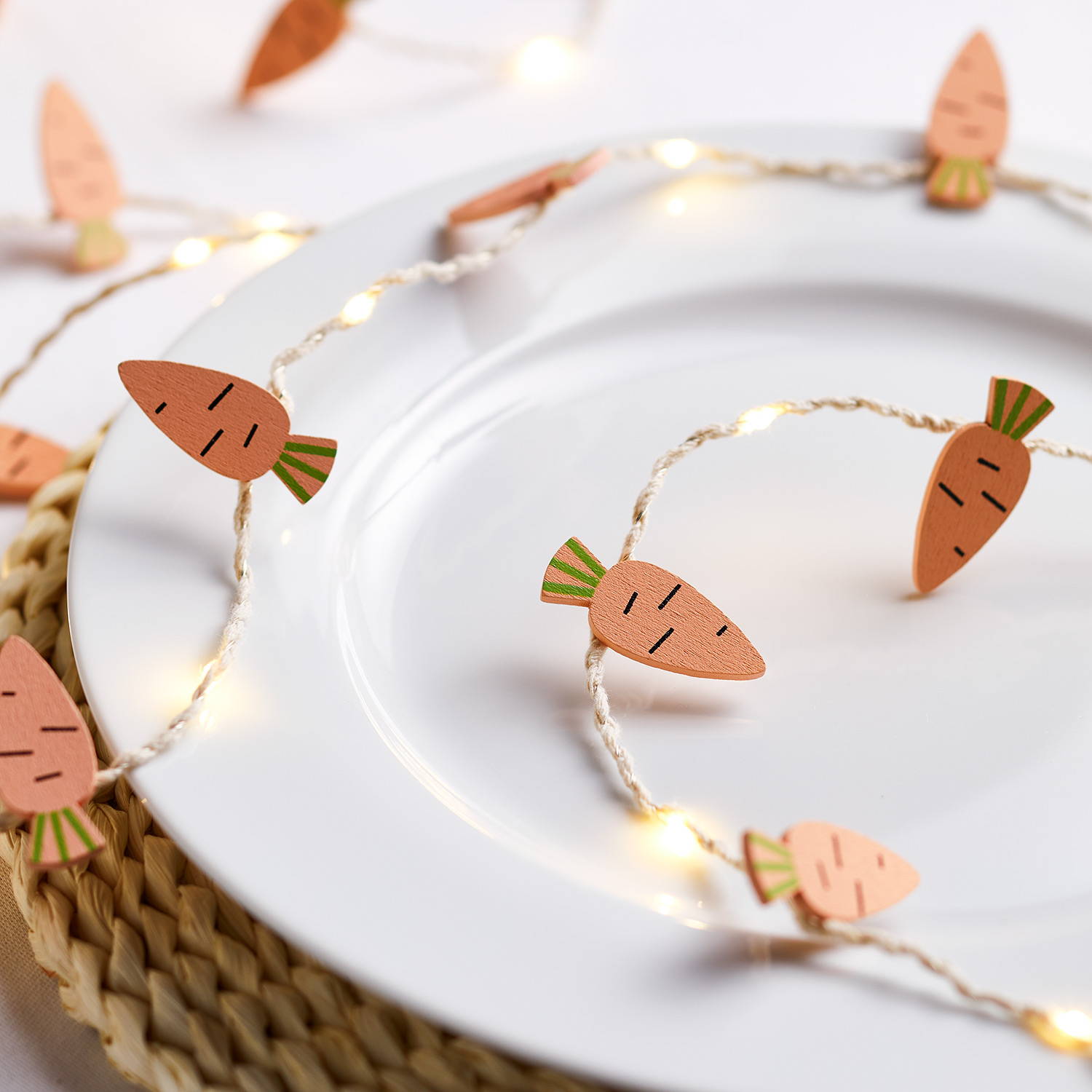Carrot micro lights illuminated on place setting on table