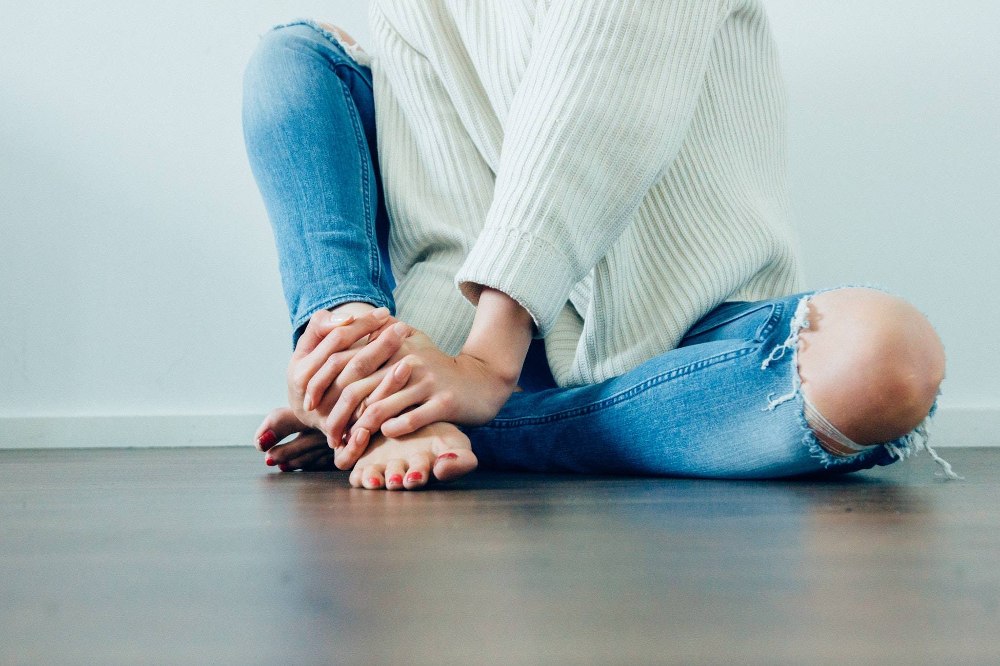 girl grasping her foot