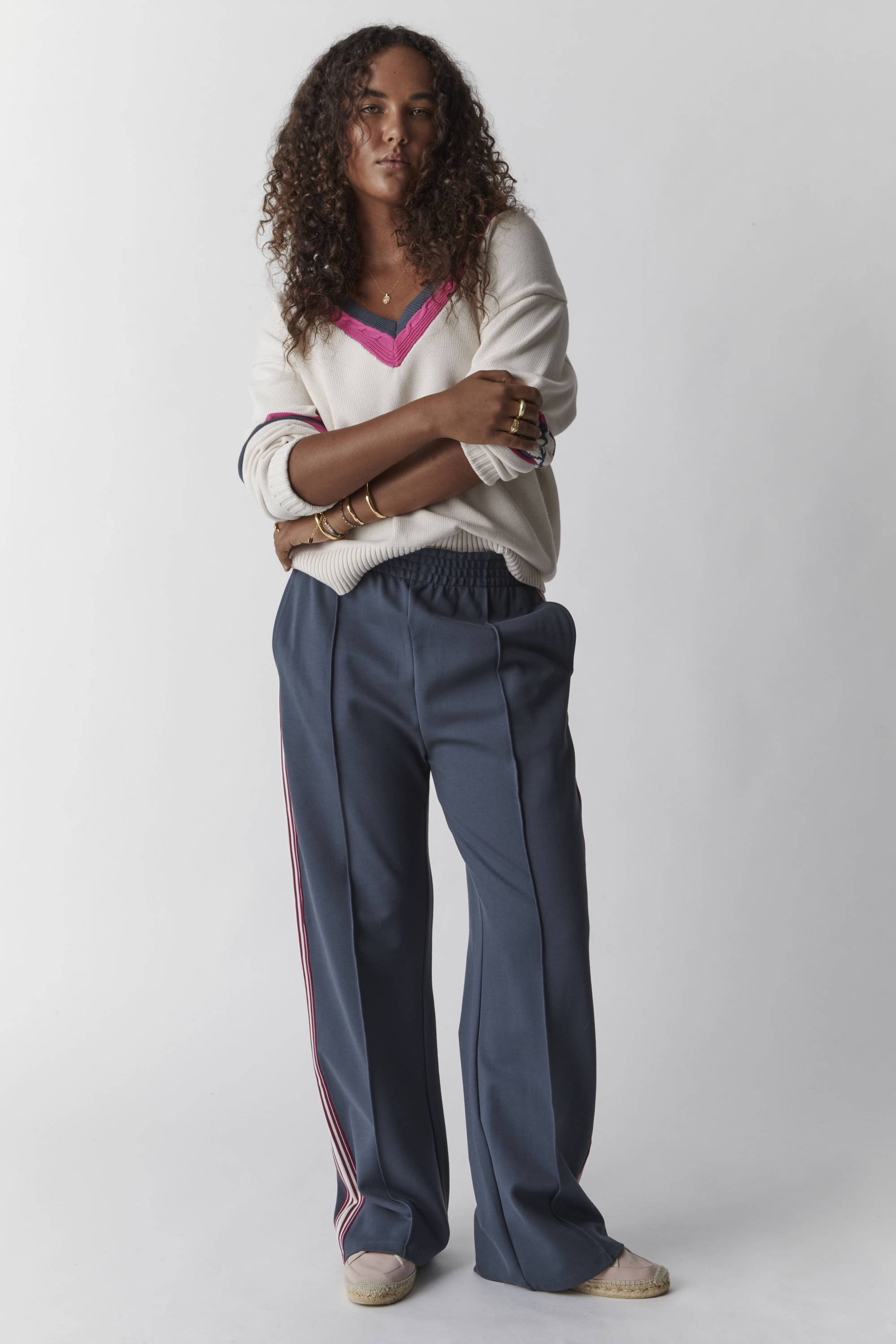 THE UPSIDE white Peggy Knit Sweater and blue petrol Niseko Monte Pant. Shop pants.