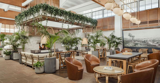 Modern restaurant interior with greenery and stylish seating arrangements.