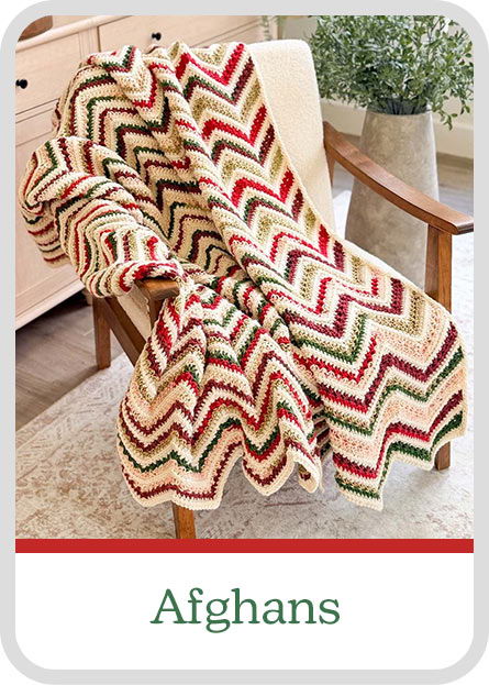 A patterned crochet blanket draped over a chair, labeled 