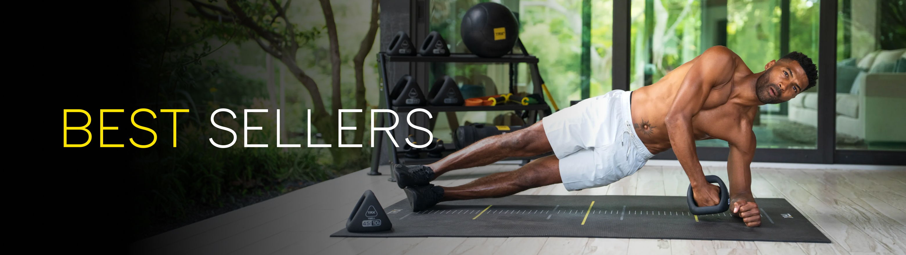 Man performing a side plank exercise in a gym setting.