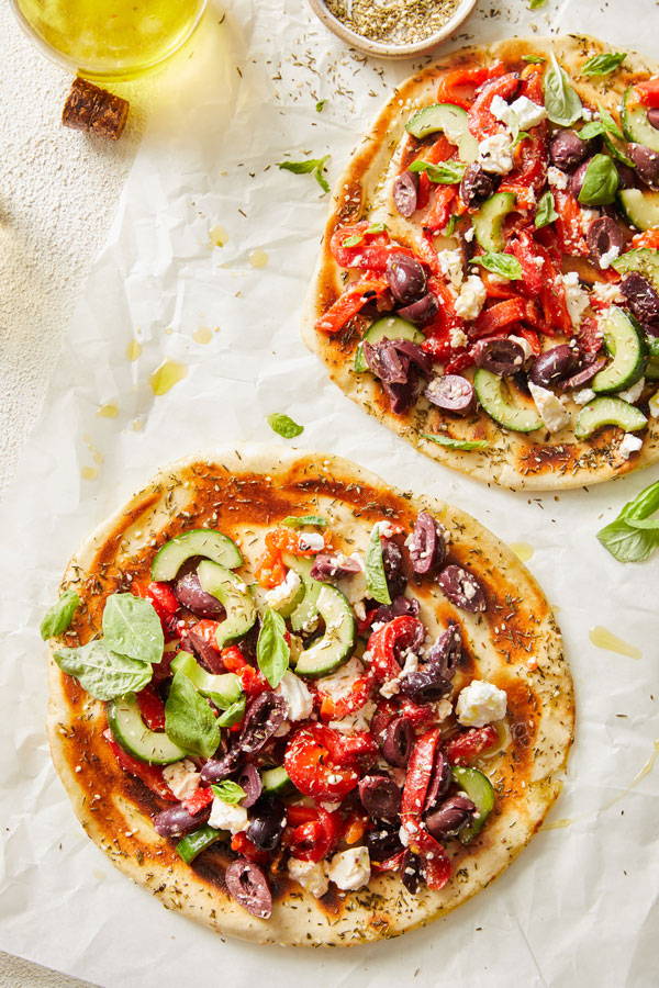 Flatbread topped with crunchy sliced cucumbers, roasted red peppers, calamata olives and feta cheese