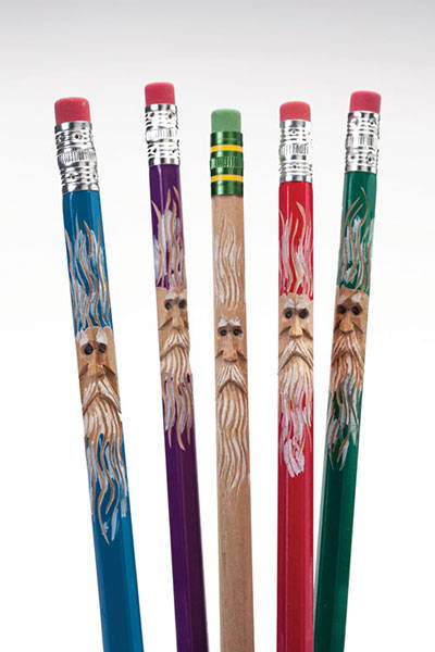 completed pencil spirits project - showing 5 different colored pencils with wood spirit faces carved