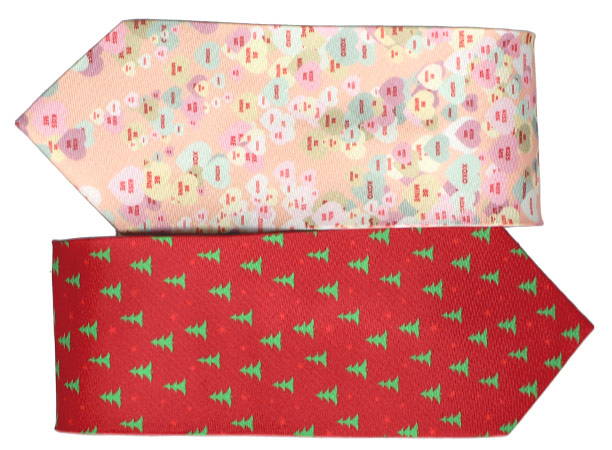 Two classic men's necktie stacked on top of one another. The top necktie is a light orange background with candy heart pattern. The bottom necktie is a red background with green pine trees.