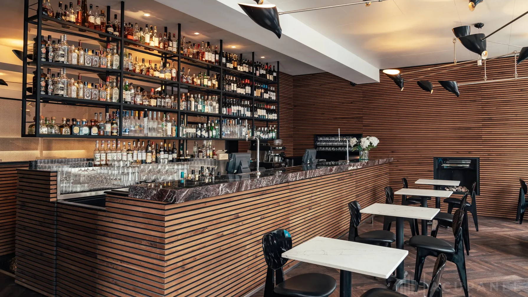 As popular restaurant setting using acoustic wall paneling in oak with an oil applied.