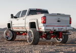 Rear three-quarter view of lifted white Silverado 2500HD thumbnail