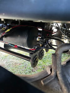 Air tank and wiring viewed under Ford F150 bed