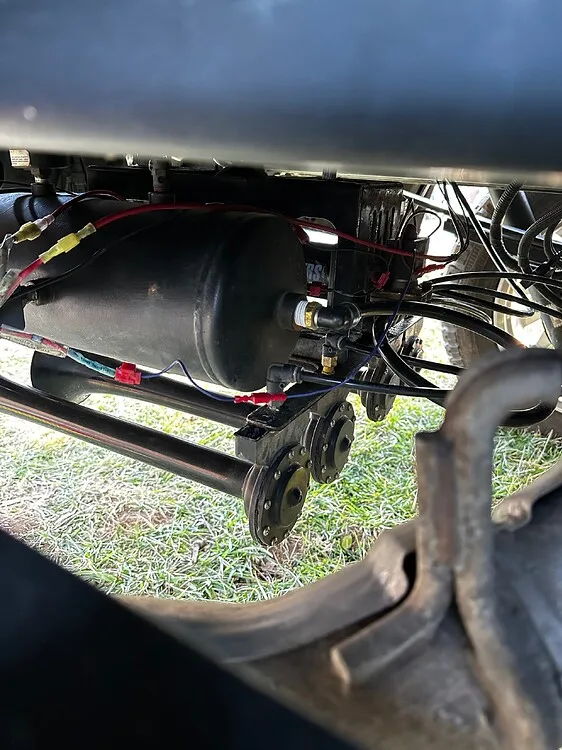 Air tank and wiring viewed under Ford F150 bed