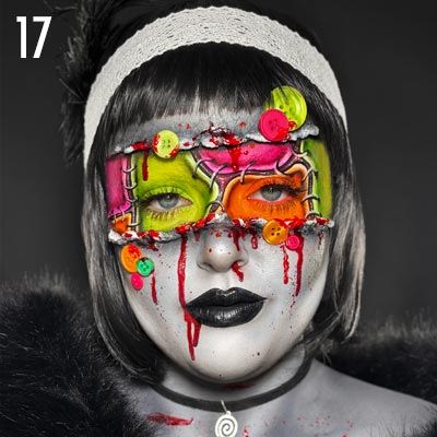 A person with colorful face paint and unusual eye coverings, with dramatic makeup.