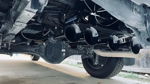Five train horns above rear differential leaf springs exhaust spare tire concrete driveway Stephen's Conductor's Special 244 Spare Tire Delete gallery photo 3