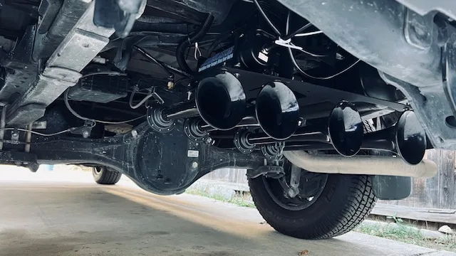 Five train horns above rear differential leaf springs exhaust spare tire concrete driveway Stephen's Conductor's Special 244 Spare Tire Delete gallery photo 3
