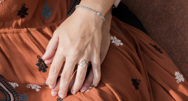 engagement ring selfie with hand holding sporting a unique modern solitaire engagement ring