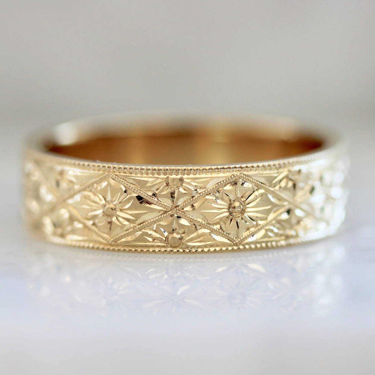 gold band with intricate flower engraving