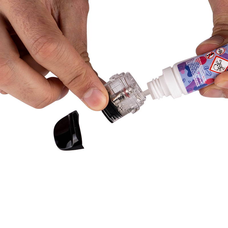 A photo showing a vape pod being filled with e-liquid