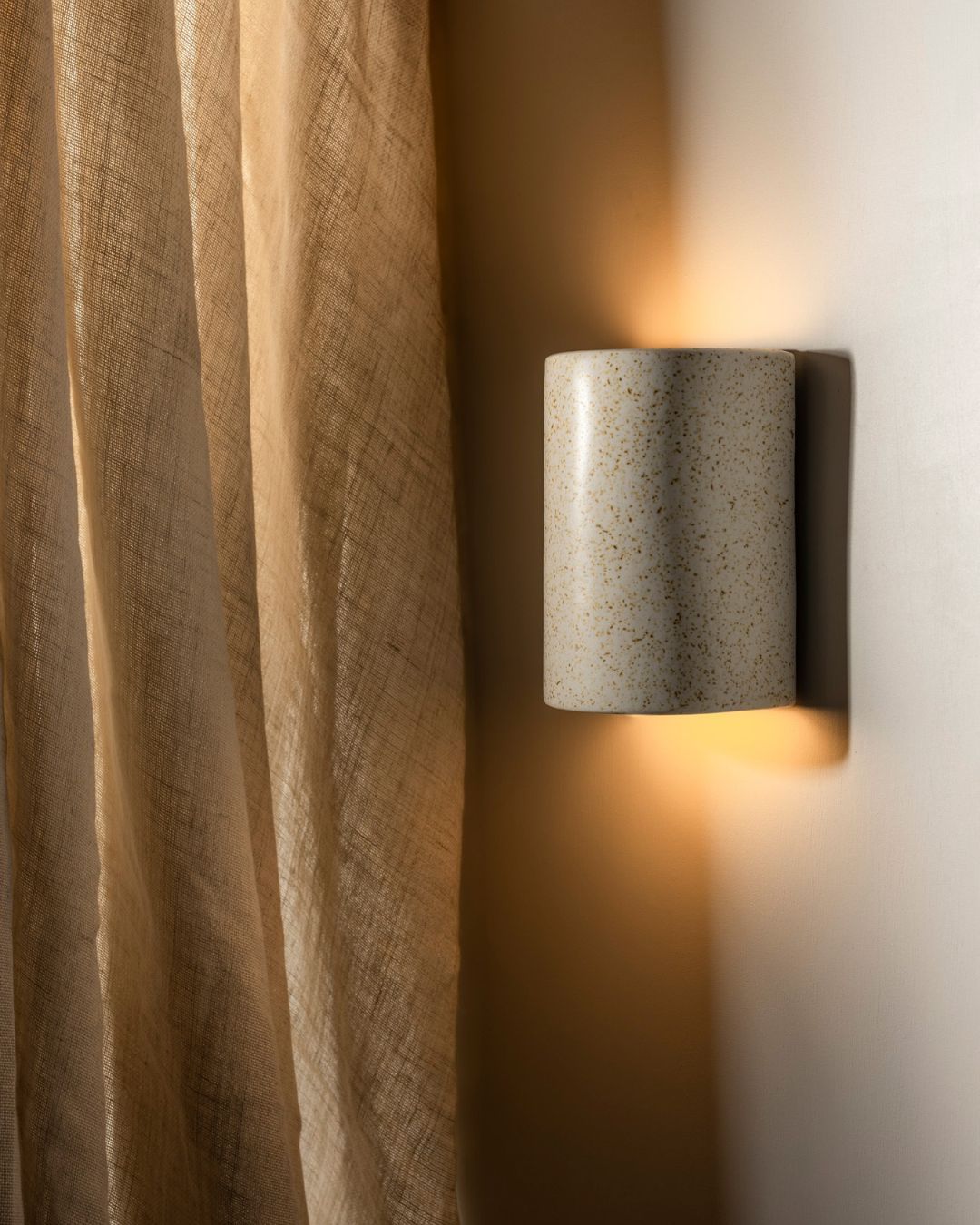 Short curved wall light with speckled finish 