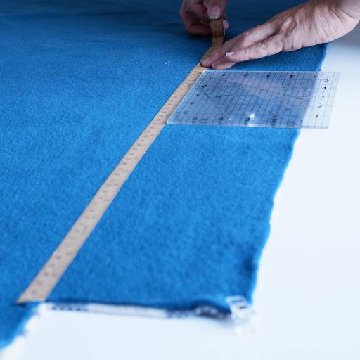 Using craft tape to cut strips on a fleece blanket
