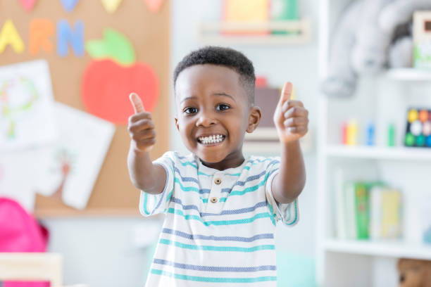 Child holding up a thumbs up