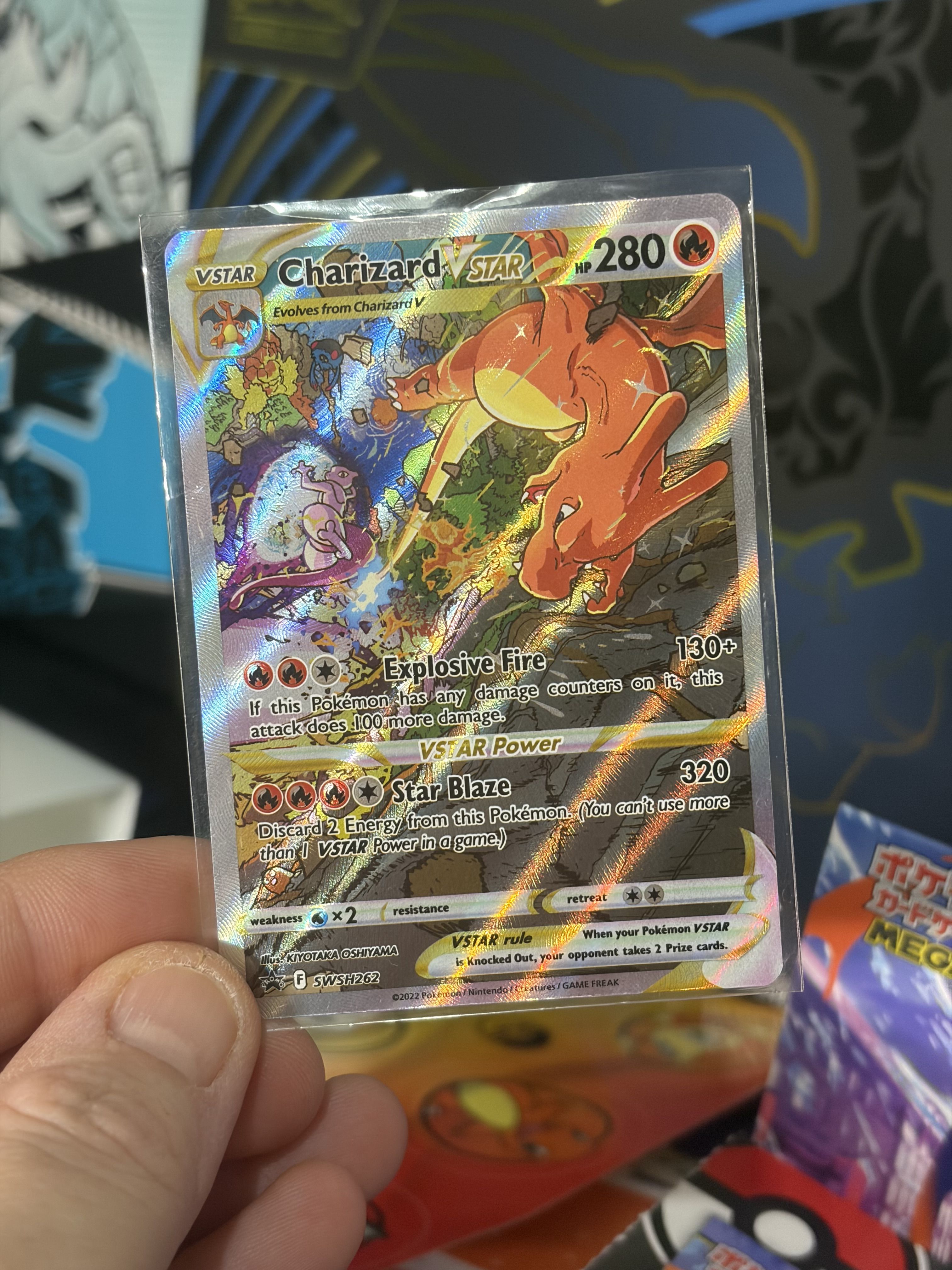 A hand holding a shiny Charizard V Pokémon card.