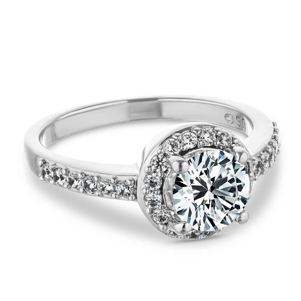 Engagement Ring shown with a 1.0ct round cut Lab-Grown Diamond in a halo setting of recycled diamonds that also run halfway down the shank and set in recycled 14K white gold