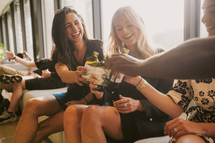 A group of co-workers enjoy beers at the office