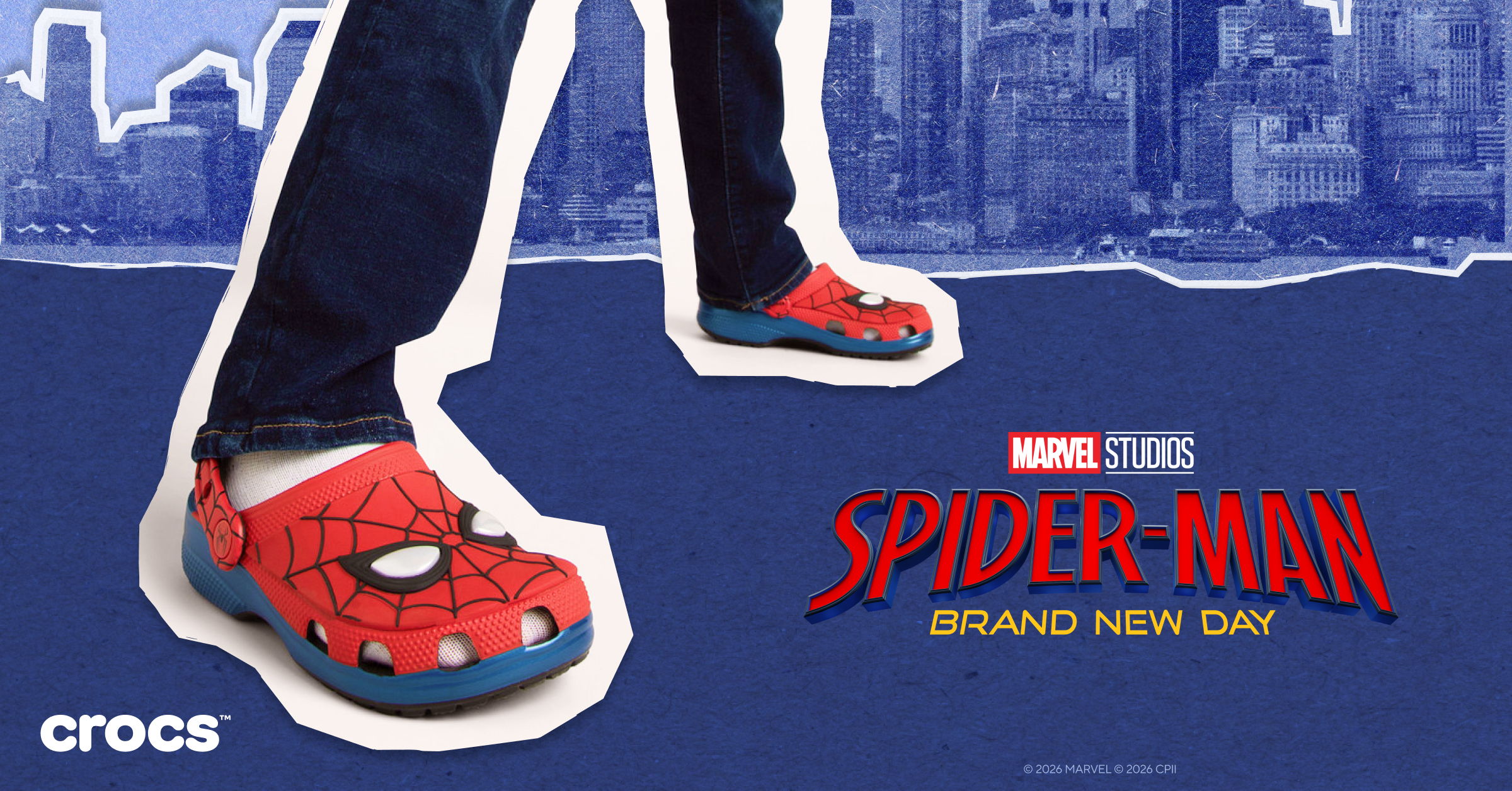 Spider-Man themed Crocs worn with denim, featuring a cityscape background.