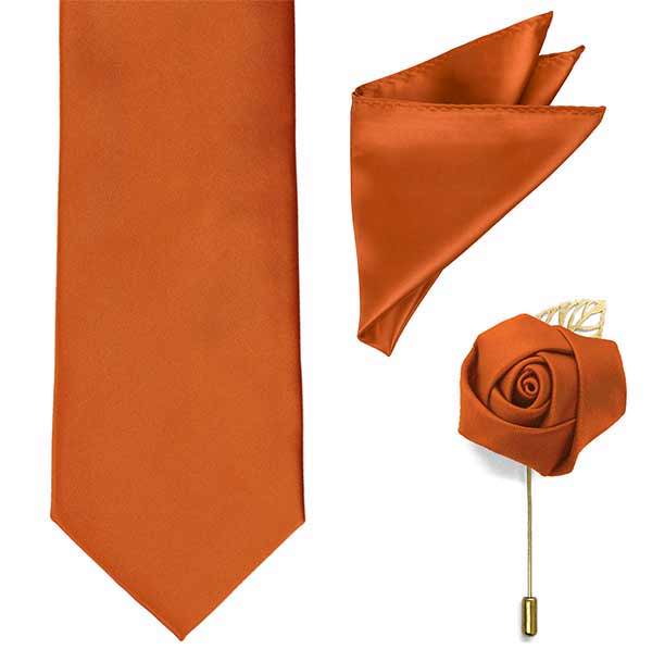 A burnt orange necktie, pocket square and lapel pin.