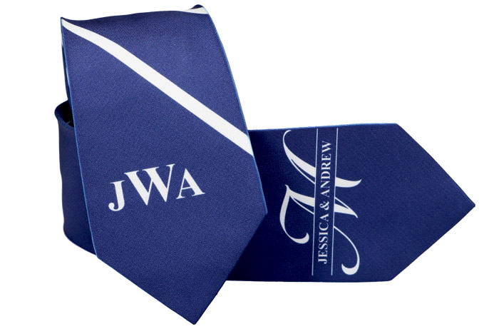 Two custom wedding ties in blue and white, one has a monogram and stripes and the other has a bride and groom's name and initial