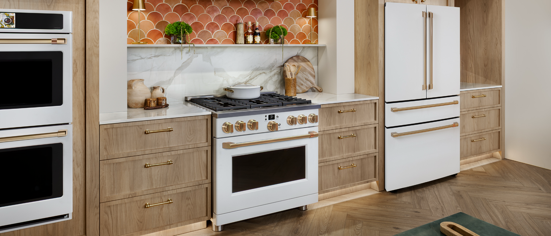 Modern kitchen with white appliances and wooden cabinetry.