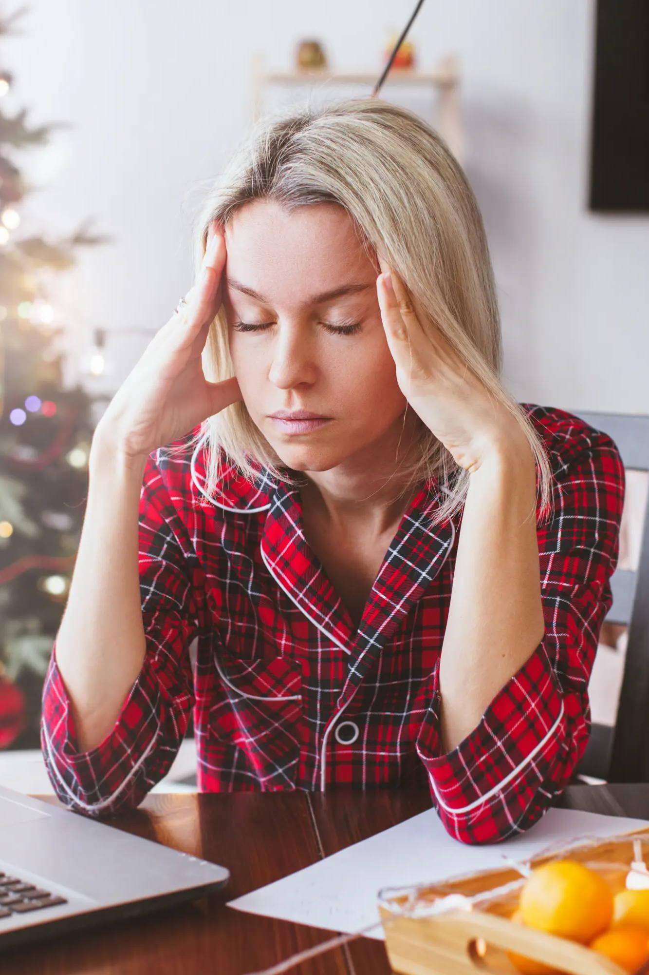 woman stressed at desk around the holidays