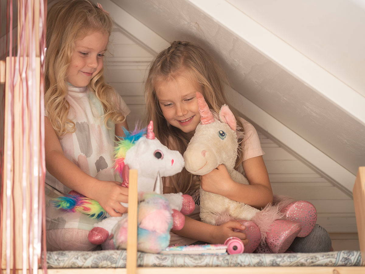 Kids playing in the loft of the Wooden Playhouse Unicorn by WholeWoodPlayhouses