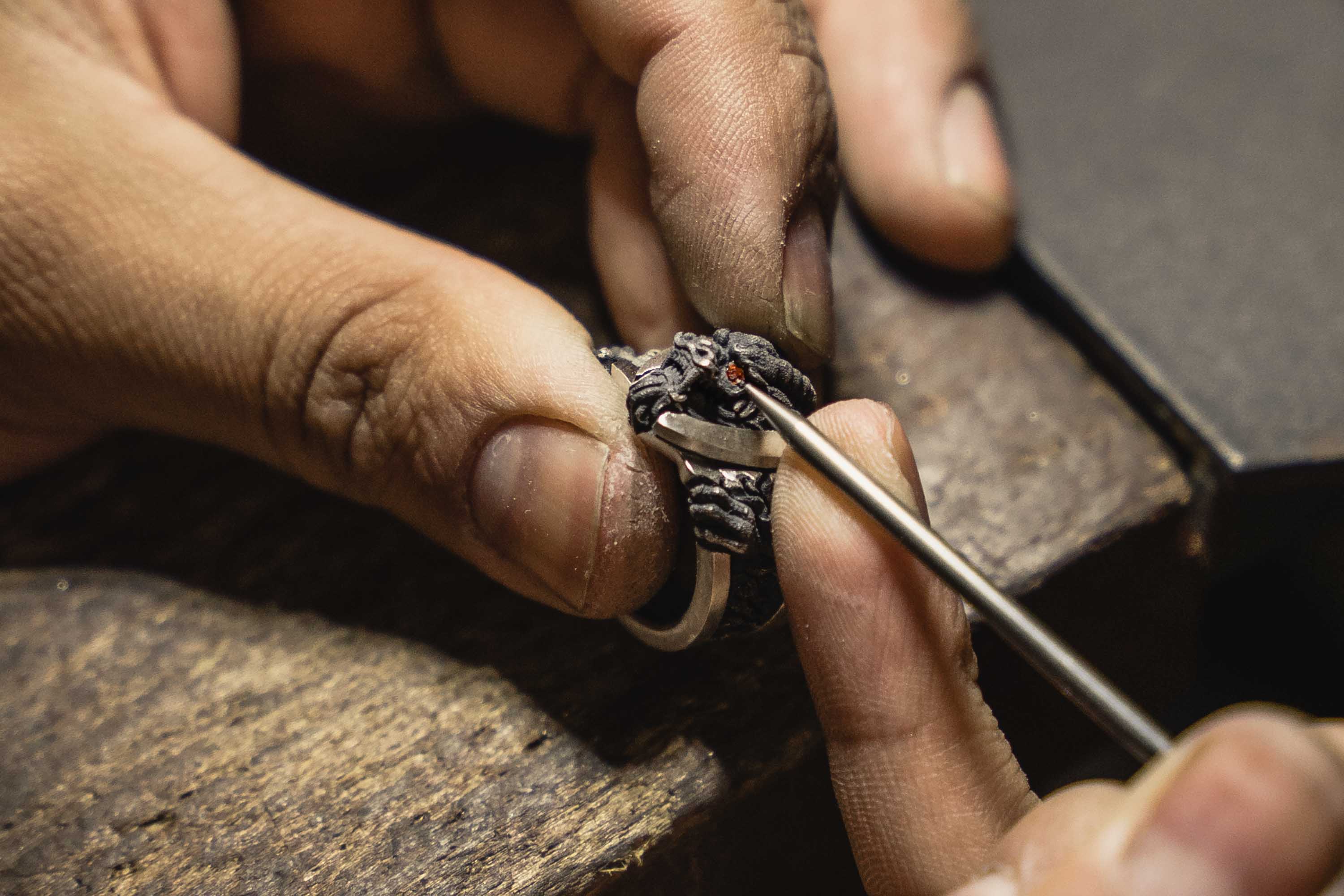 A Master Jeweler sets a gemstone in a Bushido Band from NightRider Jewelry
