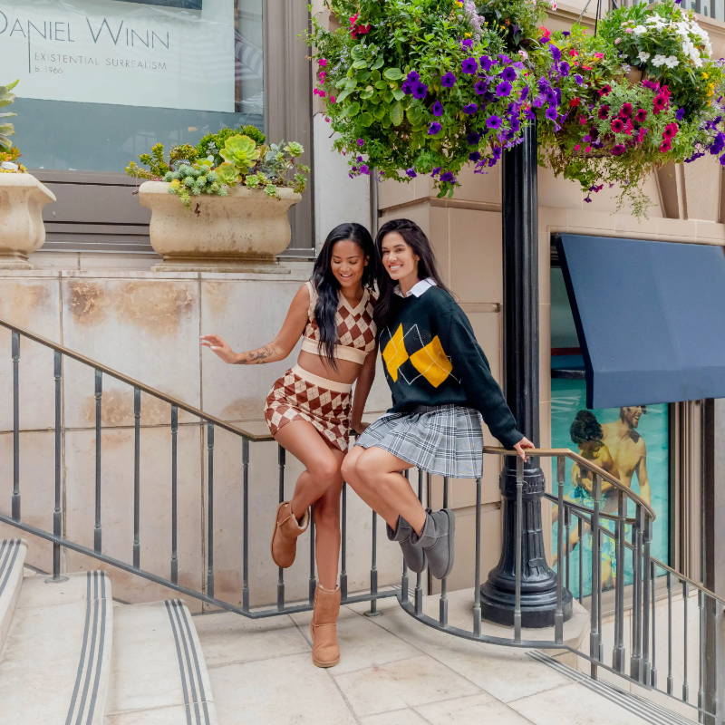 two female models wearing ugg boots on rodeo drive steps