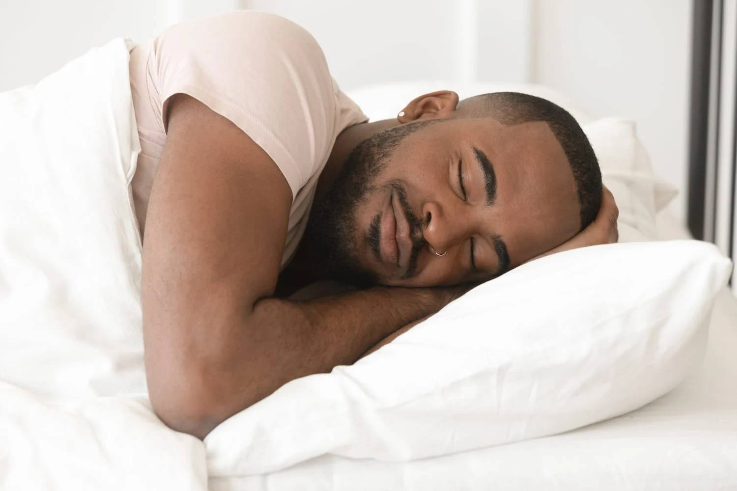 man sleeping on a comfortable mattress