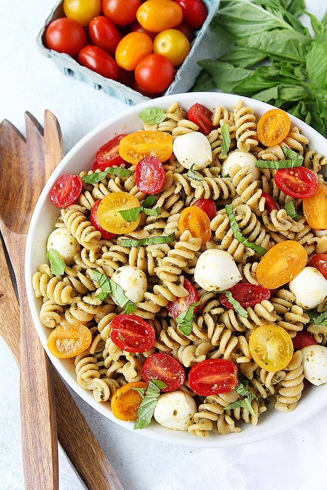Pesto pasta salad with fusilli, grape tomatoes, mozzarella and basil