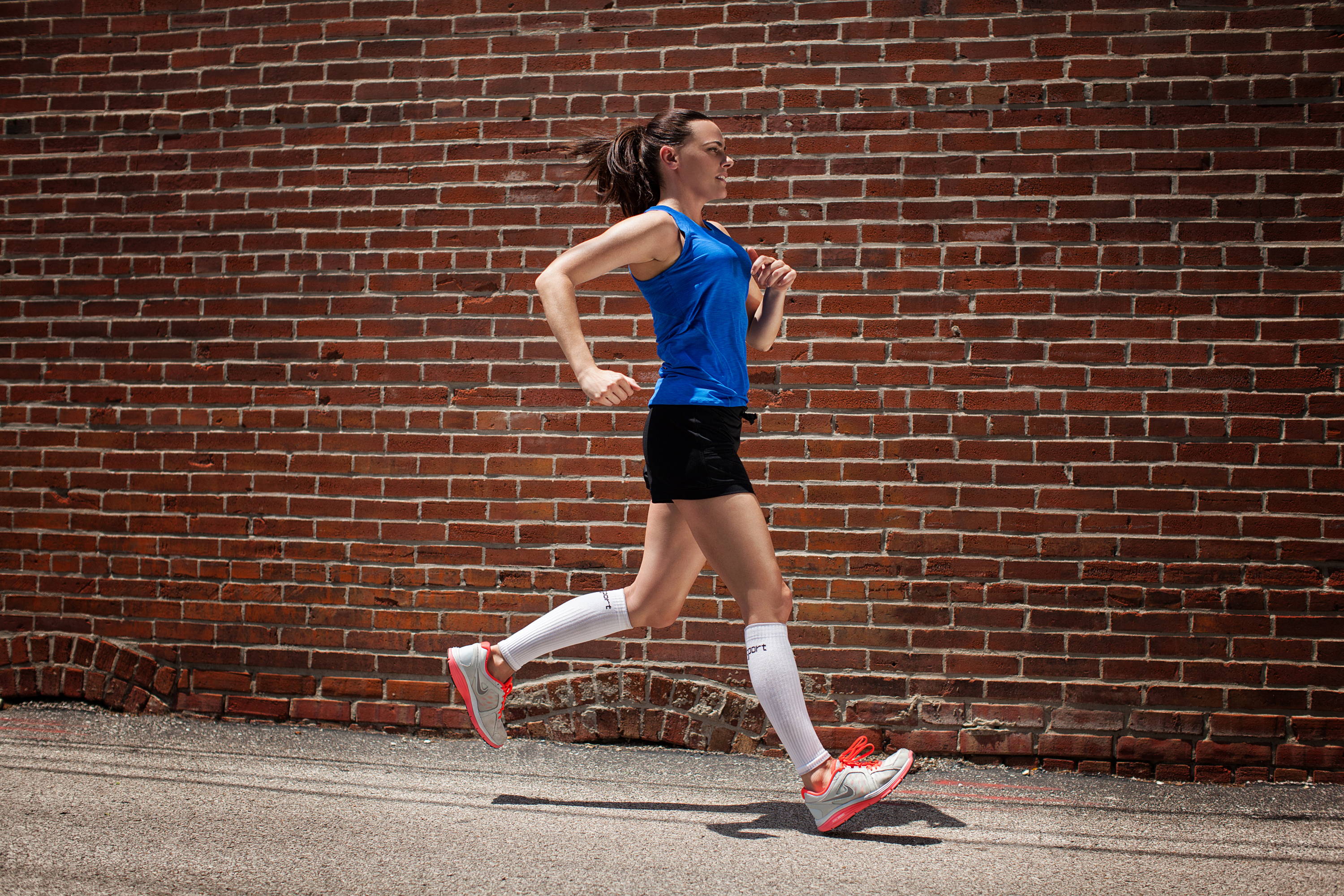 Woman running with Core-Sport compression socks