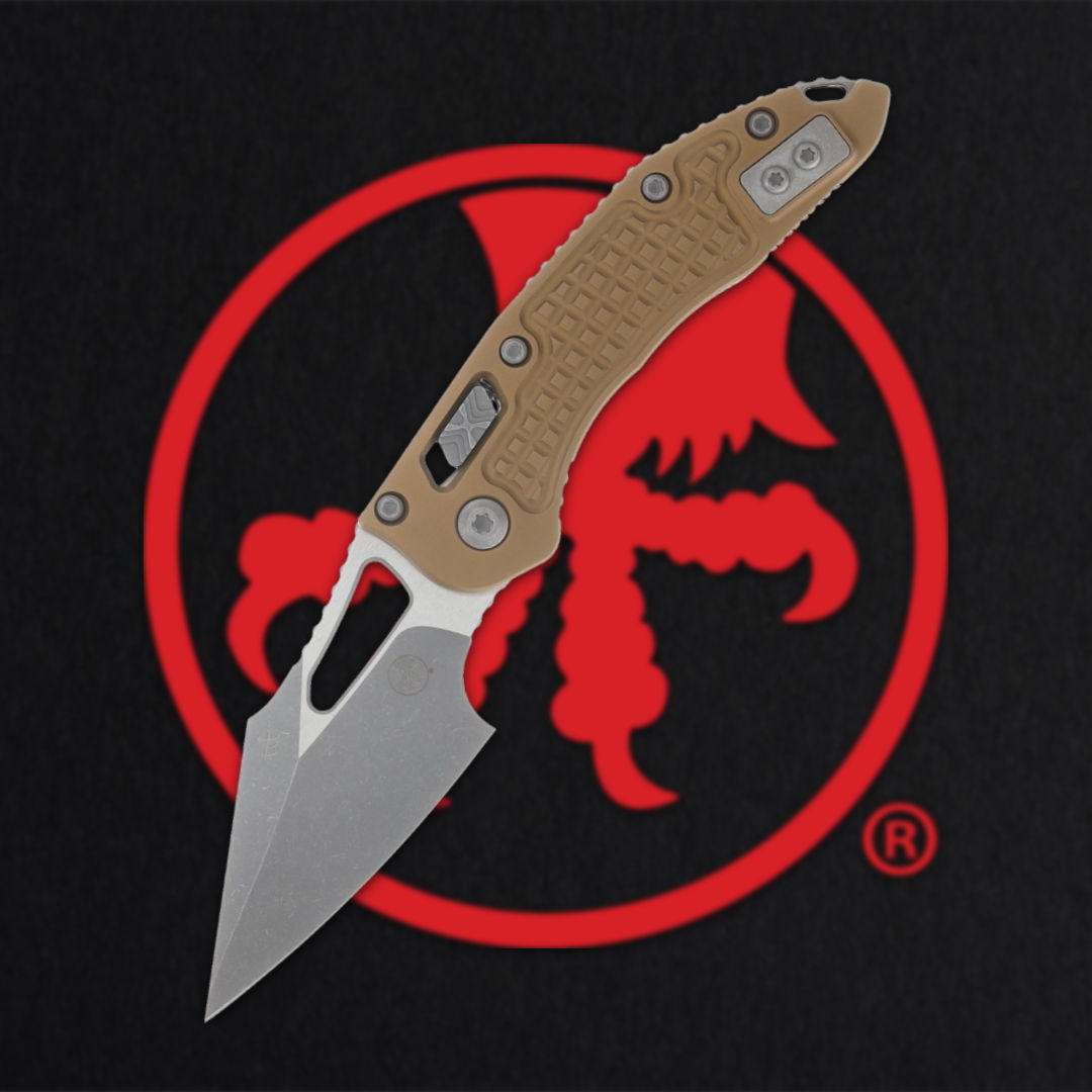 A knife with a gray blade and a tan handle on a dark background.