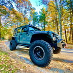 Front three-quarter slate blue 2014 Jeep Wrangler Rubicon Nitto Mud Grapplers autumn forest road Donn's Conductor's Special 244 Nightmare Edition train horn kit featured customer install gallery photo 1