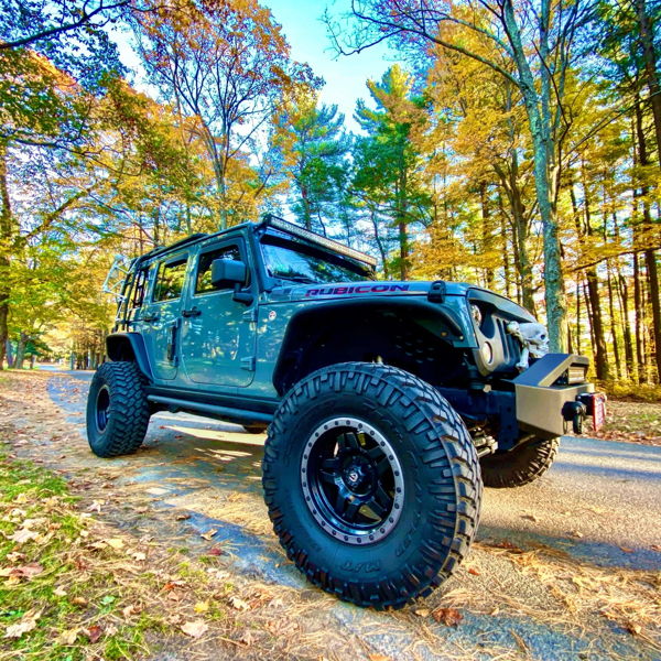Front three-quarter slate blue 2014 Jeep Wrangler Rubicon Nitto Mud Grapplers autumn forest road Donn's Conductor's Special 244 Nightmare Edition train horn kit featured customer install gallery photo 1